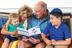 Image of grandparents reading to grandchildren