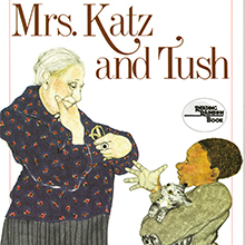 Book cover art for Mrs. Katz and Tush. A young boy holding a kitten conversing with a woman, Mrs. Katz.