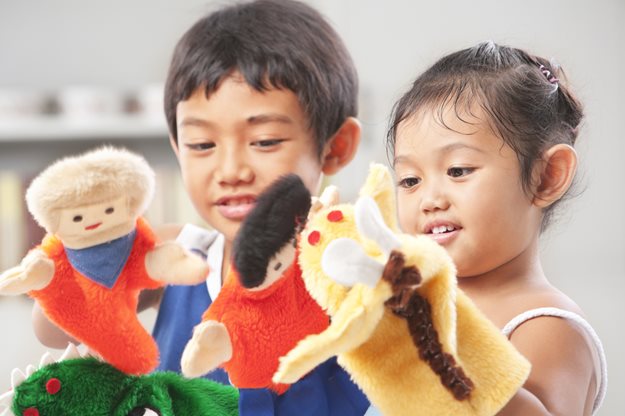 Sibling playing with puppets