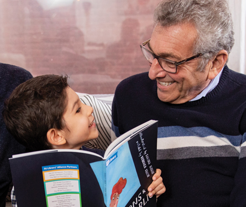 Photo of grandfather reading to child