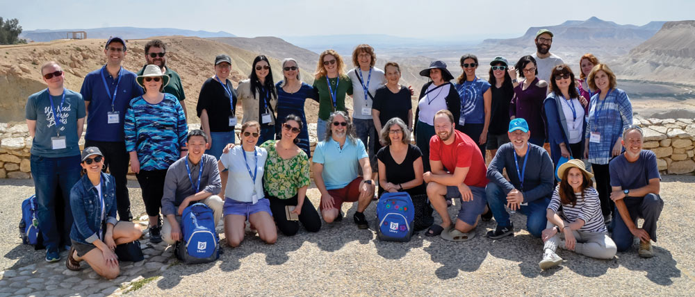 A large group photo of authors in Israel