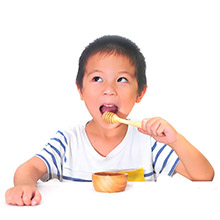 Child eating honey