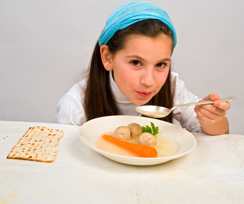 A girl eating matzo ball soup