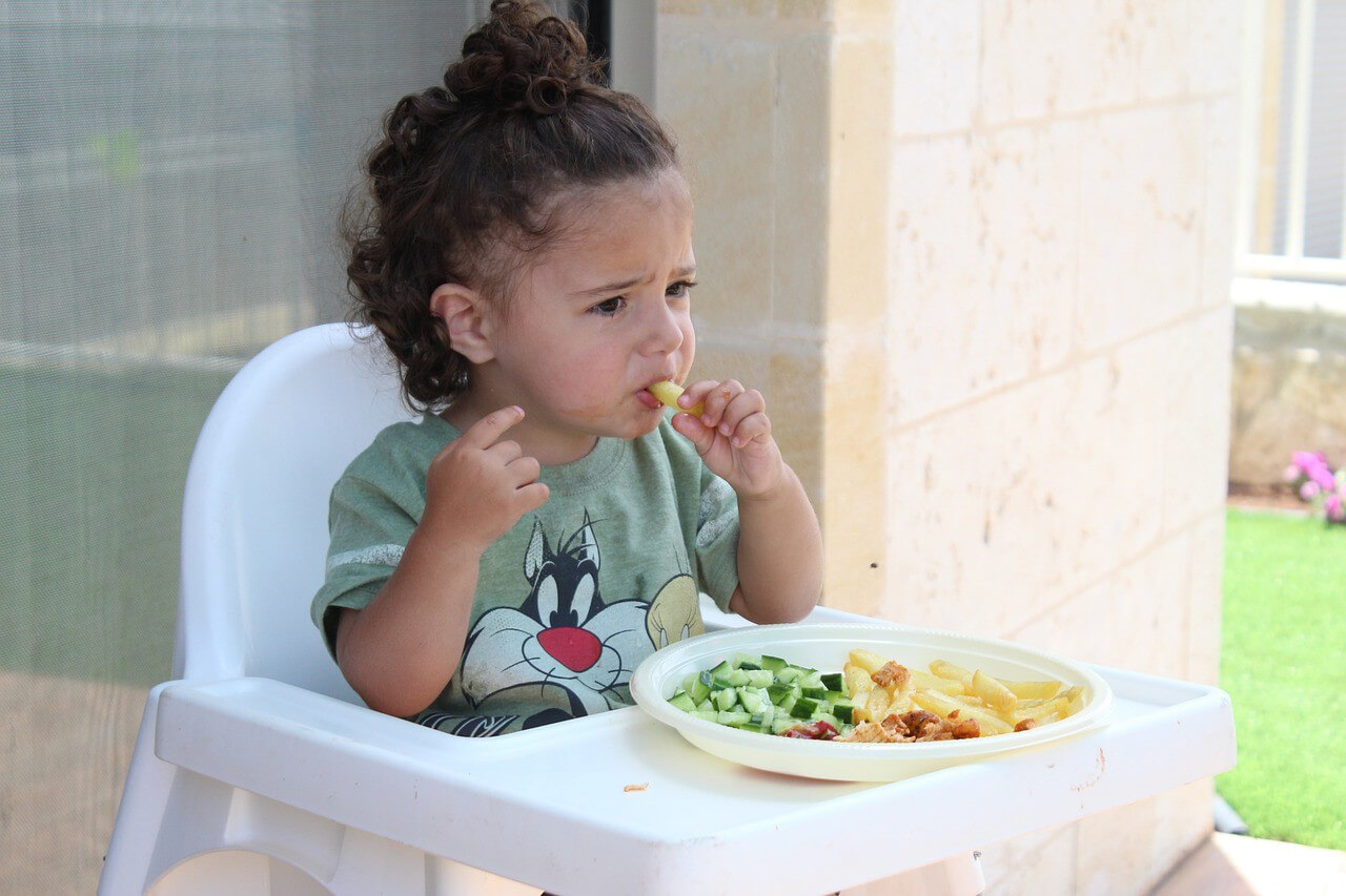 Toddler eats veggies