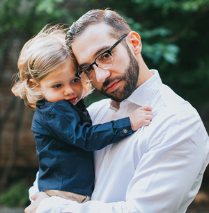 A father holding his young daughter