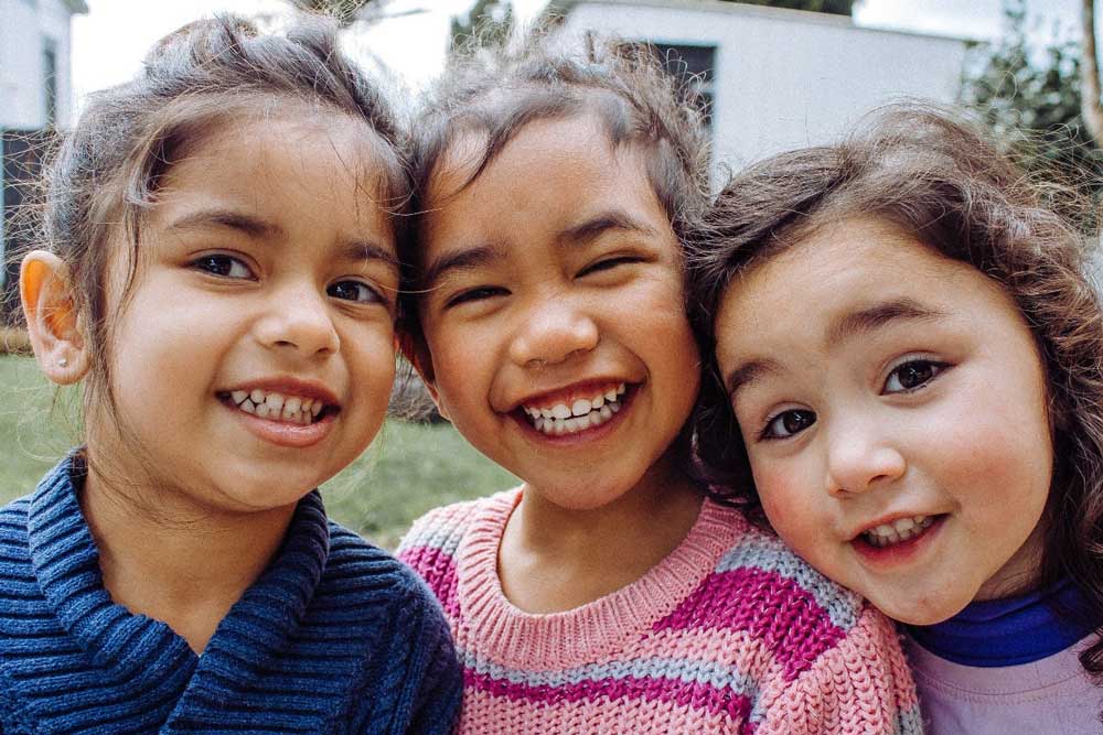 Three friends smiling