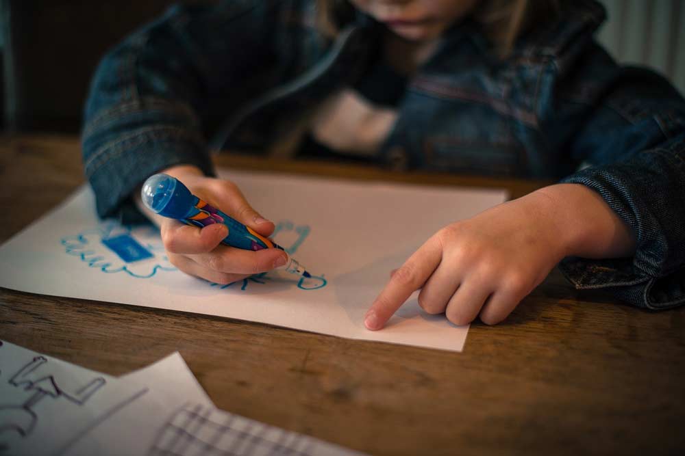 A child creating art with a marker