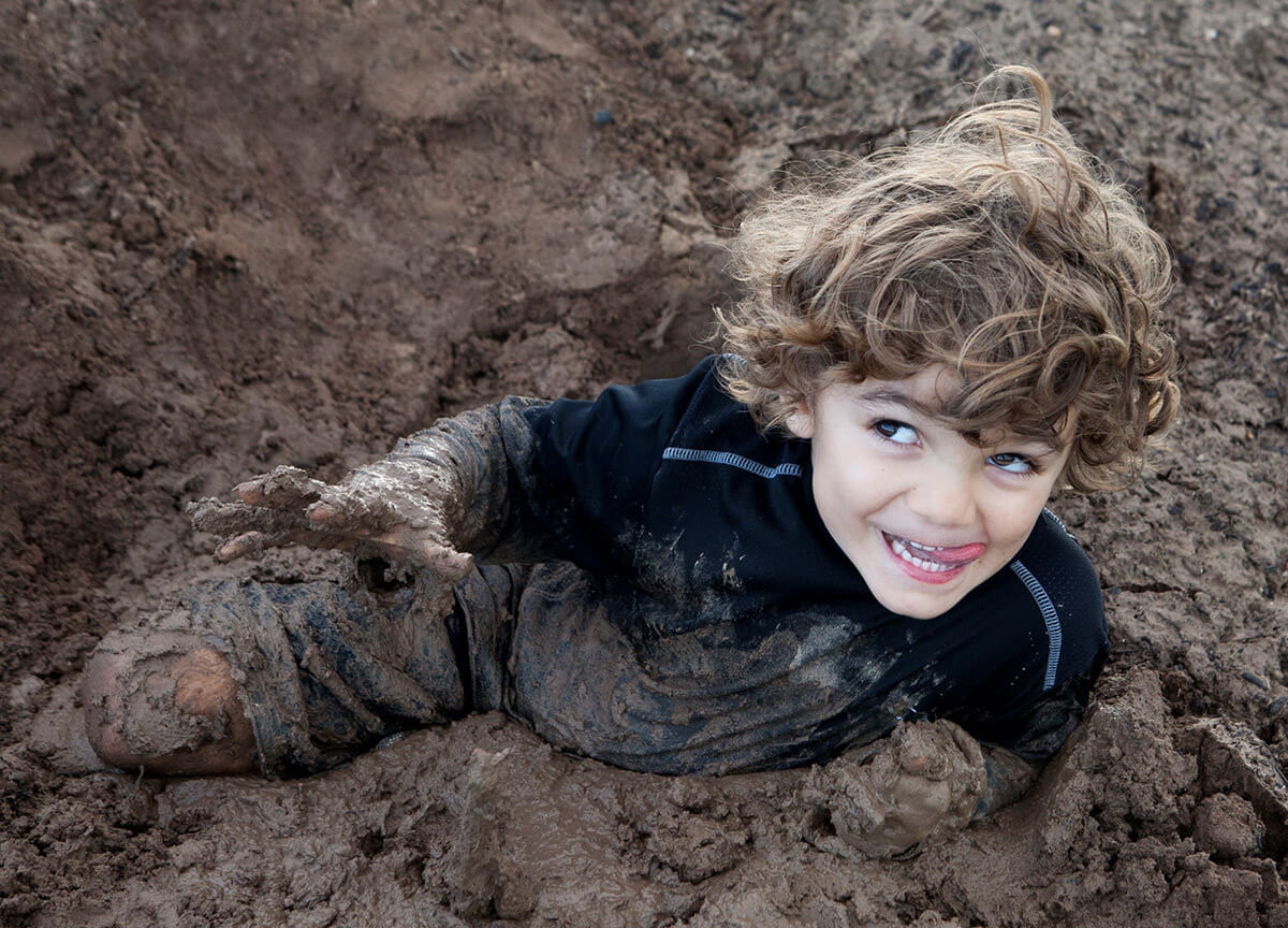 Boy Playing in Mud