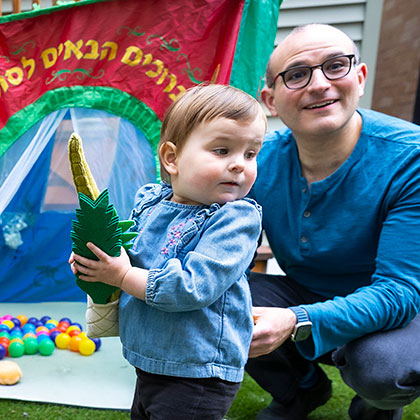 A child holding a toy lulav