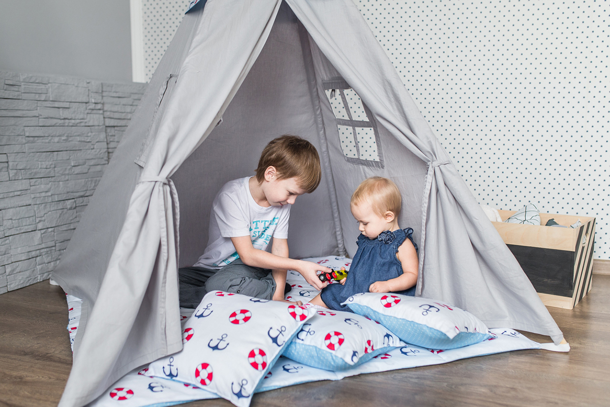 Kids playing in tent with pillows