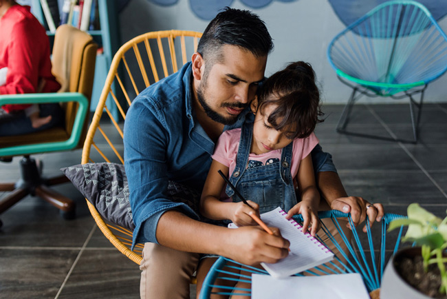 A father and daughter writing together