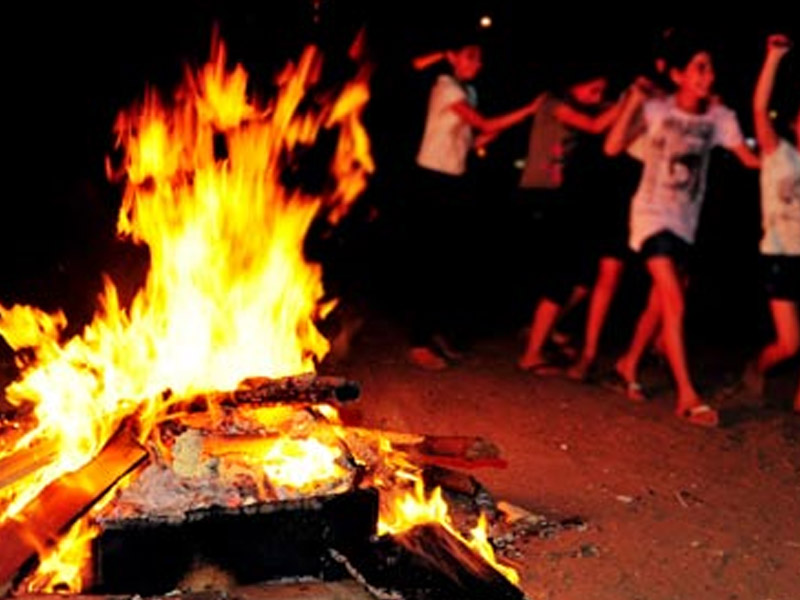 A campfire with children dancing
