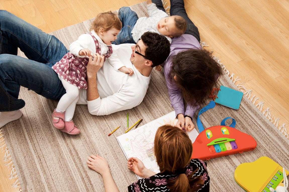 Kids playing on the floor with parents
