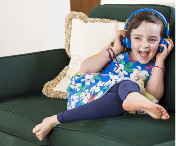 Little girl wearing blue headphones