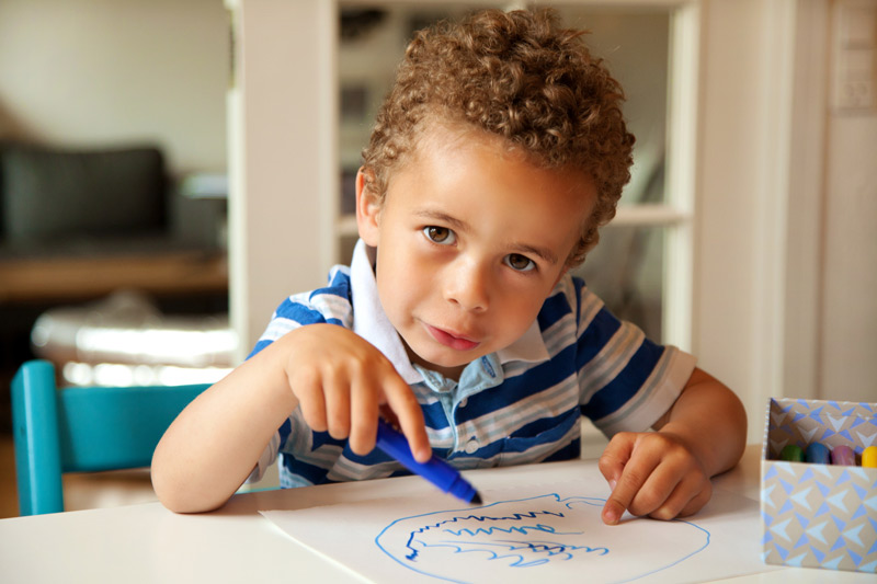 A child drawing with markers