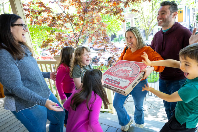 Families meeting on a porch for a get-together
