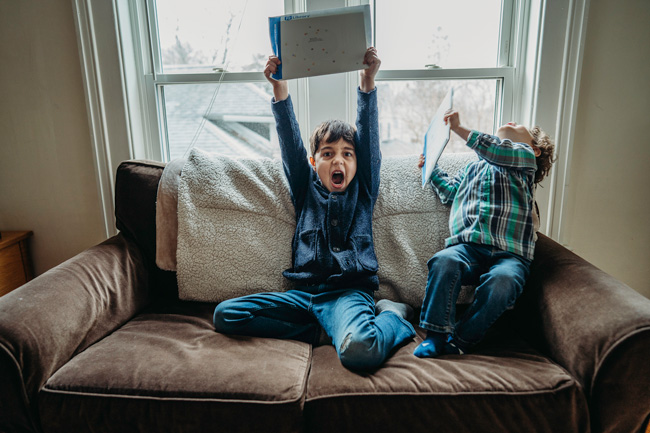 Two boys excited after receiving a gift from PJ Library