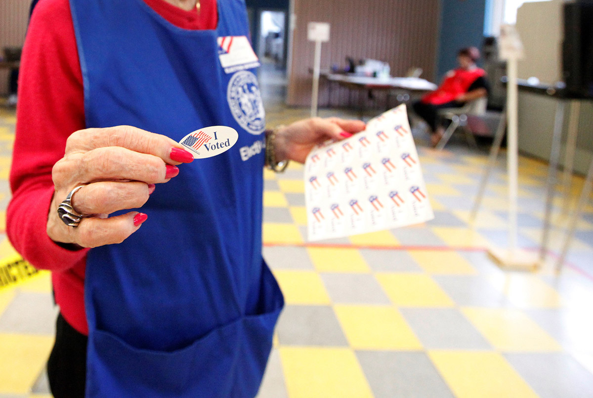 Election Volunteer Holding I Voted Sticker