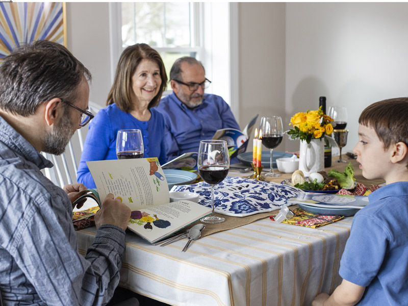 A parent reading the PJ Library Haggadah to children.