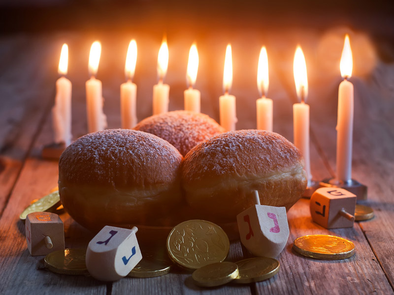 A Hanukkah themed spread of food and menorah