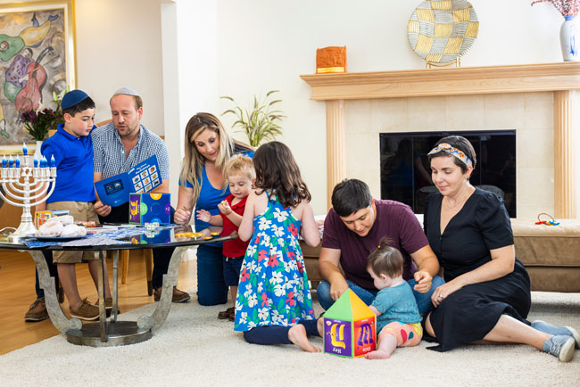 A family doing multiple hanukkah related activities