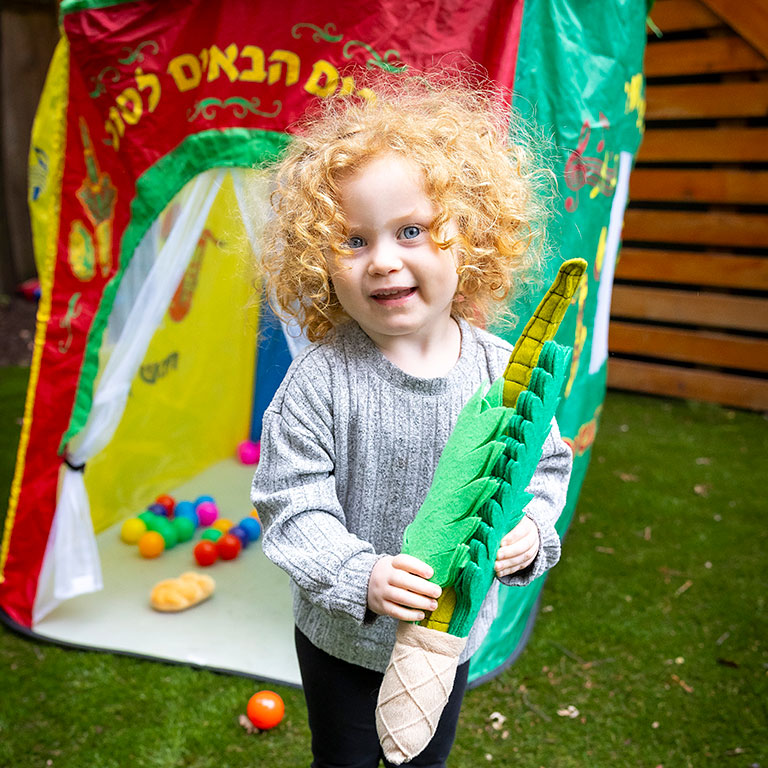 A happy child with a etrog toy
