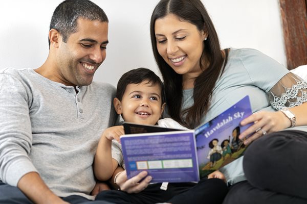 Family reading a PJ Library book together
