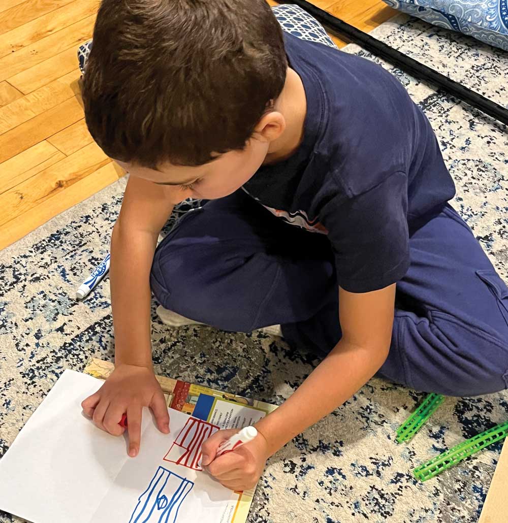 boy drawing card on floor