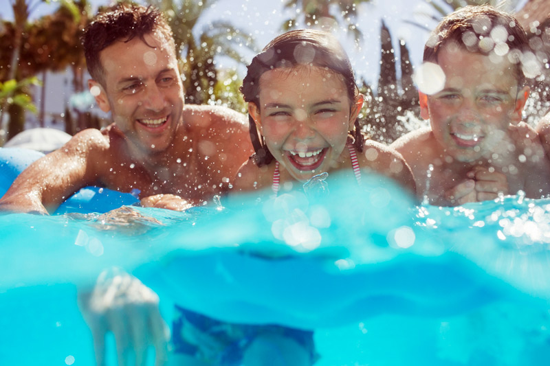 Father and kids swimming