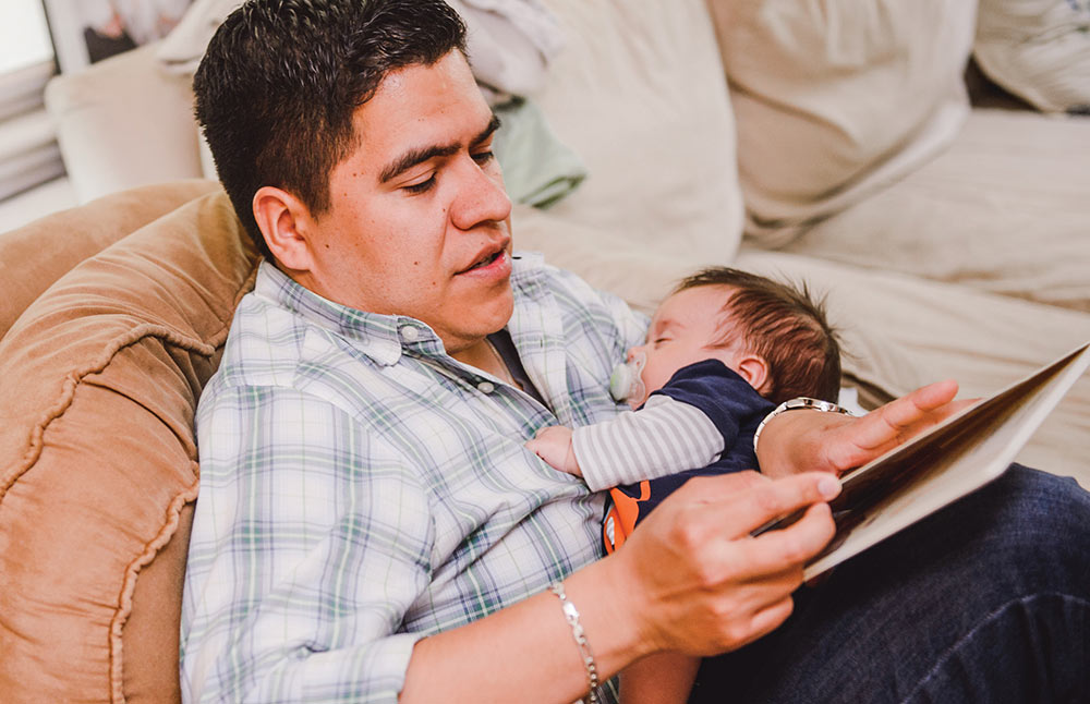 father reading to infant