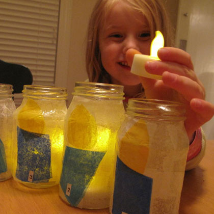 A child making battery operated candle upcycled jars